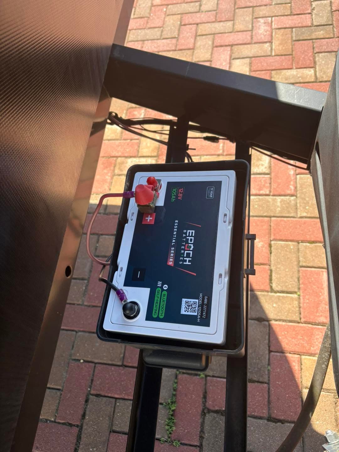 Epoch Essential Series 12V 105Ah heated Bluetooth LiFePO4 battery in a battery box on a travel trailer tongue