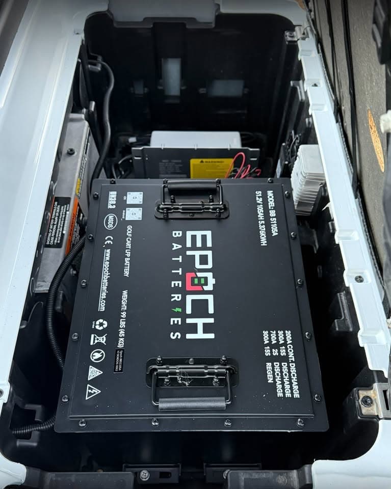 Epoch Big Box 48V 105Ah LiFePO4 golf cart battery in the battery bay of a white golf cart