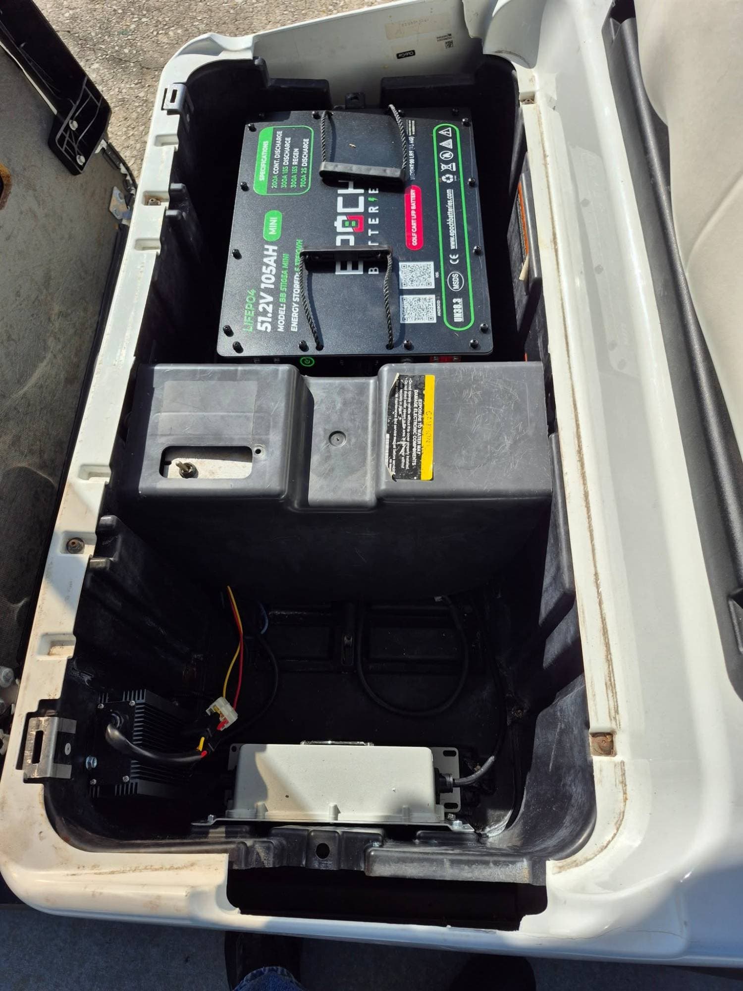 Epoch Big Box 48V 105Ah Mini LiFePO4 golf cart battery in the battery bay of a white golf cart