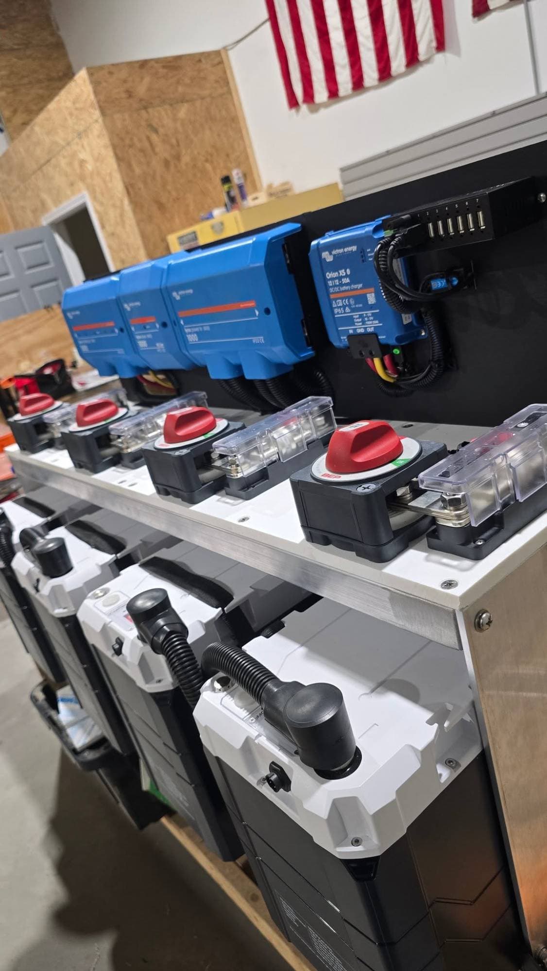 Four Epoch LiFePO4 batteries in a marine power rack with BEP battery switches, Victron Lynx modules and an Orion XS DC-DC charger